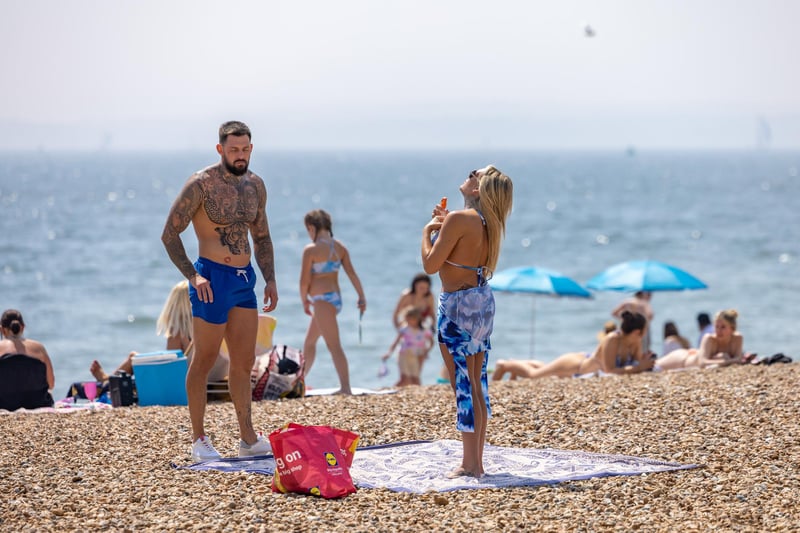 Topping up the tan cream on Southsea beach. Picture: Mike Cooter (110524)