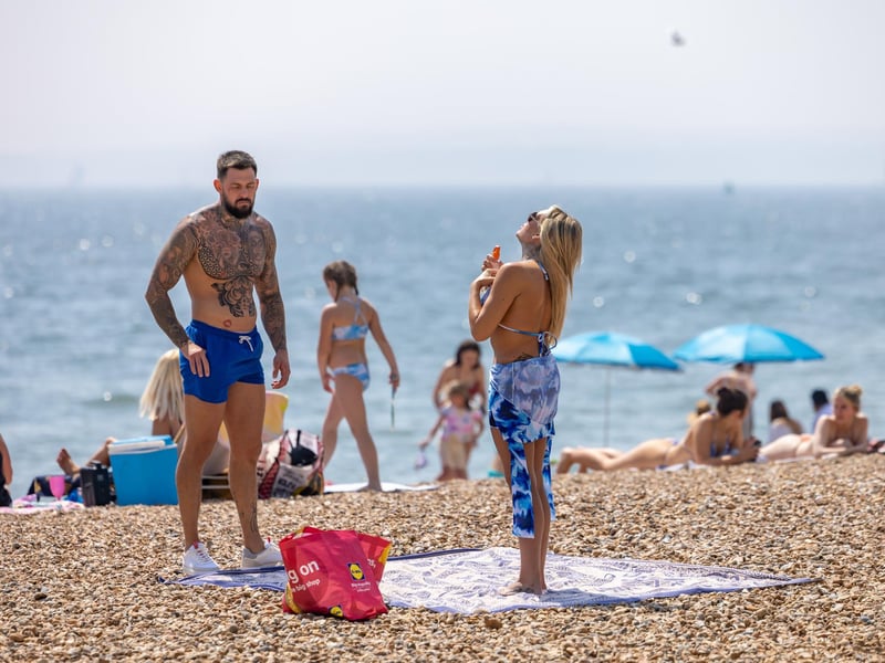 Topping up the tan cream on Southsea beach. Picture: Mike Cooter (110524)
