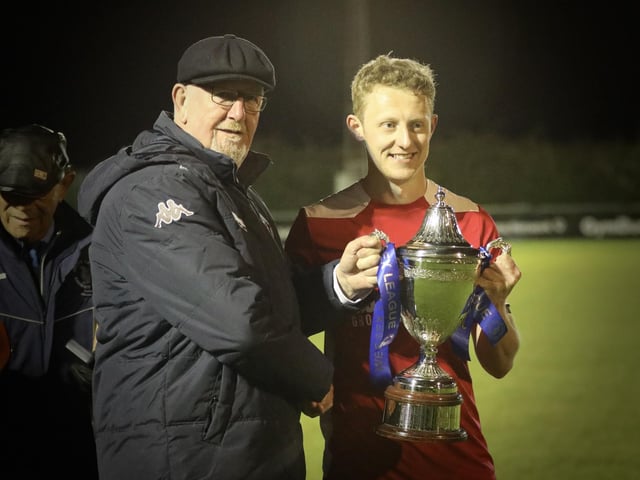 Ash Howes receives the Wessex League trophy. Picture by Martin Denyer