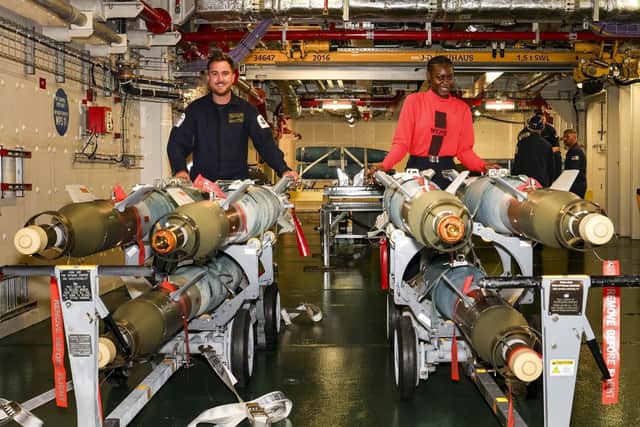 A Royal Navy sailor and a US sailor with 6 built bombs, which were loaded onto the F-35 jet before it set off from the HMS Prince of Wales flight deck. Picture: LPhot Finn Stainer-Hutchins