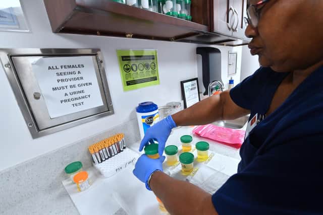The rates of sexually transmitted illnesses per local authority have been released, including the data for Portsmouth.  Pictured is medical assistant Barbara Dupree, of the AIDS Healthcare Foundation (AHF) Wellness Centre, closing bottles of patient's urine submitted for testing in Hollywood, California. Picture: FREDERIC J. BROWN/AFP via Getty Images.
