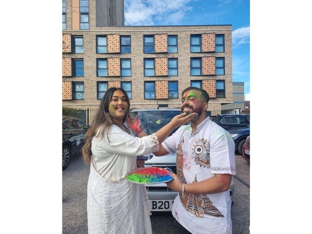 Guddu and Ripa Purkaystha wipe paint on to each others faces.