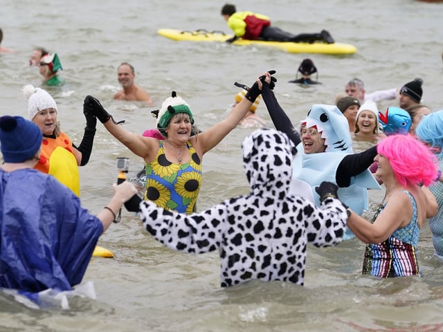 People take part in the Gosport New Year's Day Dip in The Solent at Stokes Bay, Gosport, Hampshire, to raise money for Gosport and Fareham Inshore Rescue Service. Picture date: Monday January 1, 2024.