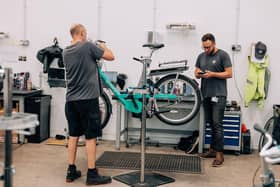 Staff in one of Beryl's workshops repairing a bike