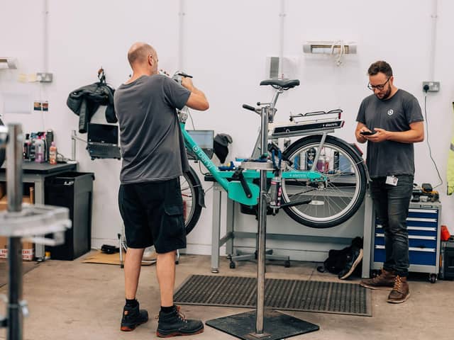 Staff in one of Beryl's workshops repairing a bike