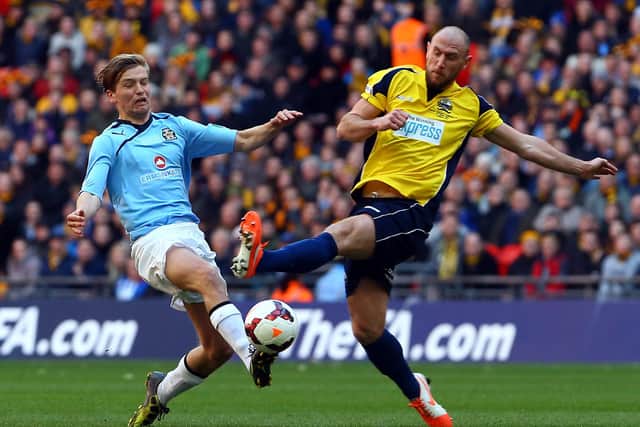 Cambridge United's Luke Berry is challenged by Lee Molyneaux during the 2013/14 FA Trophy final at Wembley.