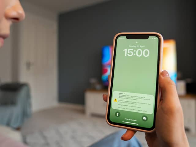 A file photo of a test of a public alert system on a mobile phone. Mobile phones will ring out with an alarm this September as the Government tests its emergency alert system.