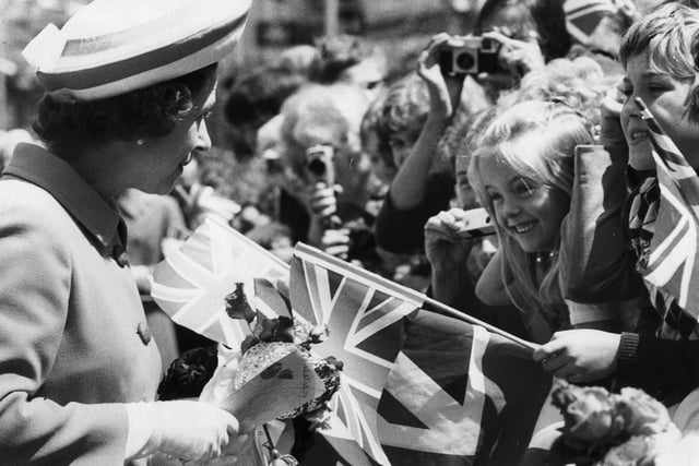 Queen Elizabeth talks to a young girl during the Commercial Road walkabout in June 1977