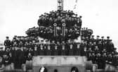 Crew member of HMS Lapwing. Here we see the officers and men of the ship gathered around A & B turrets.