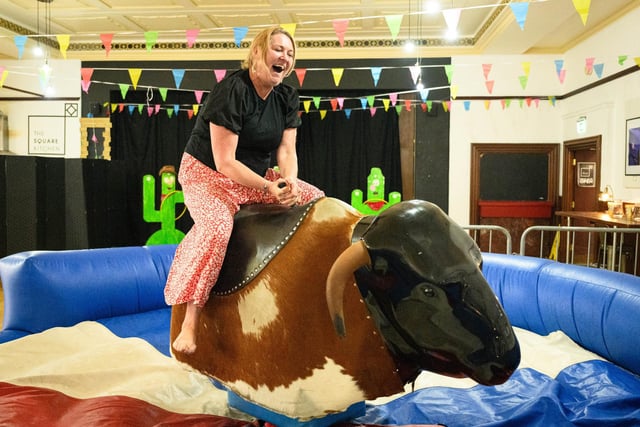 Pictured is: Emma McNally rides the mechanical bull.

Picture: Keith Woodland