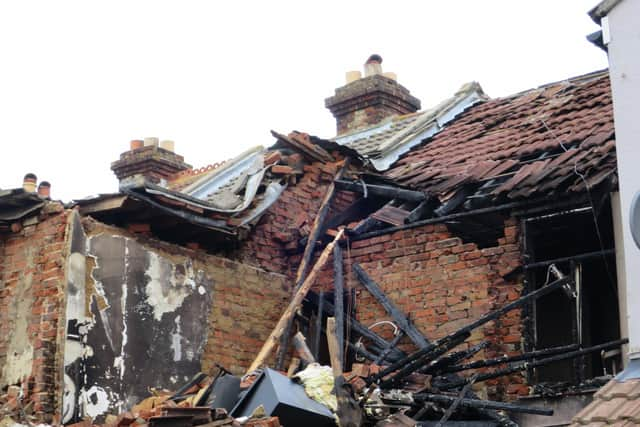 Michael McCormick with his wife Montse and their son Mark outside their destroyed home in Whale Island Way in Stamshaw, Portsmouth, on January 3 after a New Year's Day suspected gas explosion forced them to flee. Picture: Ben Fishwick