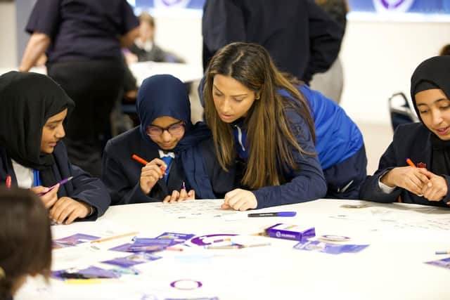 PFC Women’s player Anisha Hill with schoolgirls ©University of Portsmouth/Karen Bornhoft