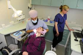Dentist Varinder Bassi examines Siobhan Spowart's teeth in the Tooth Bus in 2013, with dental nurse Deborah Casper 
Picture: Allan Hutchings (13769-272)