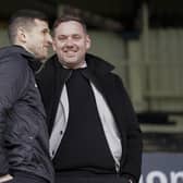 John Mousinho in discussion with sporting director Rich Hughes before Saturday's game at Peterborough