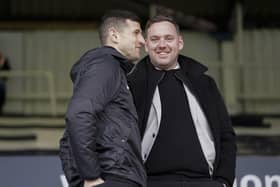 John Mousinho in discussion with sporting director Rich Hughes before Saturday's game at Peterborough