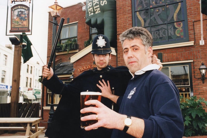 Andy Davies-Macleod, the landlord of the Fuzz and Firkin, is 'nicked' by Simon Millard, the bar supervisor durin ghte fun at the opening of the new pub, formerly Southsea Police Station in Albert Road, Southsea in February 1996 PP1513