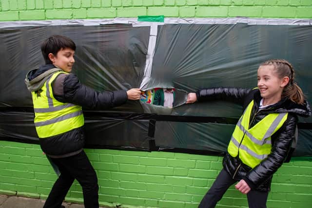 Azher, 10, and Imani, 10, unveil the first art work as other pupils watch. Picture: Habibur Rahman