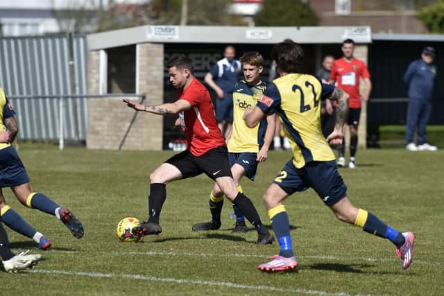 Fareham's Gary Austin (red) in action against his former club. Picture: Allan Hutchings