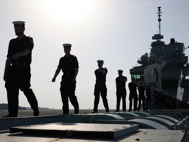 Pictured: Members of the ship's company falling out of the ceremonial party.