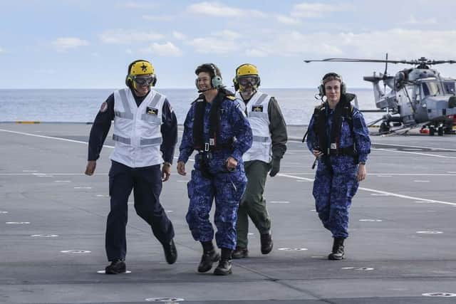 Pictured: Cdre James Blackmore greats RAdm Jeanette Morang on the flight deck of HMS Queen Elizabeth.