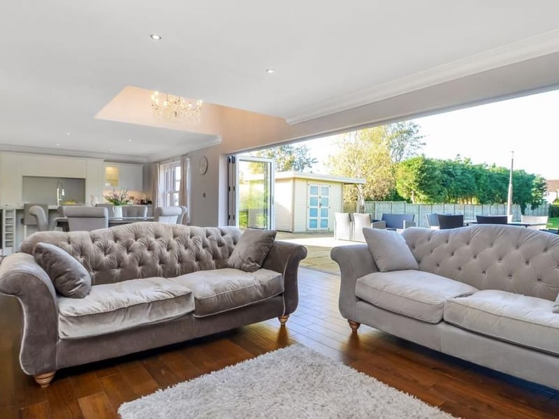 The listing says: "This symmetrical fronted family home is quite unique for the area, being a modern property within an established 1930s residential location and was built with space in mind with large windows, a light and airy feel including galleried landing, bi-folding doors and good proportioned rooms."