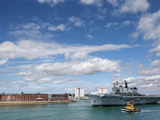 The helicopter carrier HMS Illustrious departs Portsmouth for a deployment to the Mediterranean on August 12, 2013 in Portsmouth. Photo by Oli Scarff/Getty Images