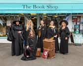 Sarah Veal (48), Jazmine Woodward (22), Kieran Slade (18), Shania Erdman (24), Barbara Veal (74) and Jessica Elshaw (16, seated) prepare for Harry Potter night outside of the outside of The Book Shop in Lee-On-The-Solent. Picture: Mike Cooter (240621)
