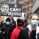 A man raises a sign during a Black Lives Matter protest at the weekend in central London. Photo by Alex Pantling/Getty Images.
