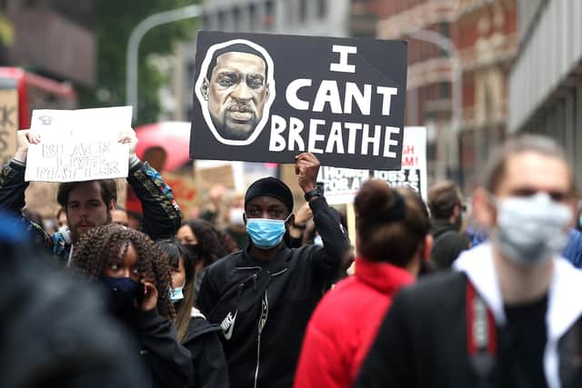 A man raises a sign during a Black Lives Matter protest at the weekend in central London. Photo by Alex Pantling/Getty Images.