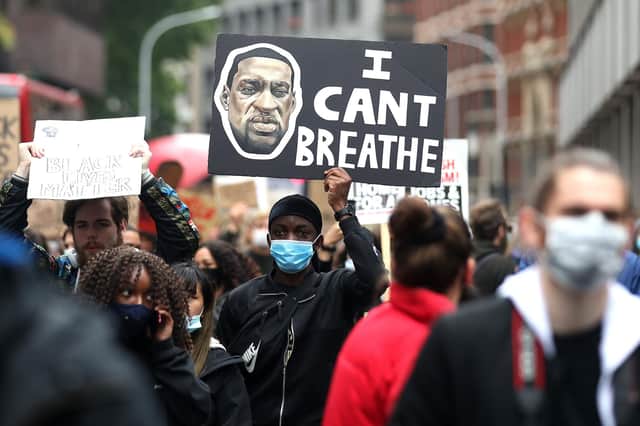 A man raises a sign during a Black Lives Matter protest at the weekend in central London. Photo by Alex Pantling/Getty Images.
