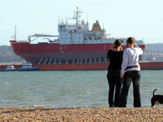 HMS Endurance moored in the solent off Gosport's Stokes Bay in 2009 piggy-back on the heavy lifting vessel Viewed, Some ladies take a photo whilst walking their dog

PICTURE: PAUL JACOBS (091303-1)