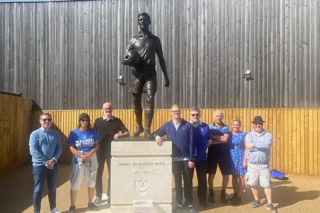 Members of Pompey Supporters' Trust pictured next to Jimmy Dickinson's statue, which they helped drive the fundraising for. Picture