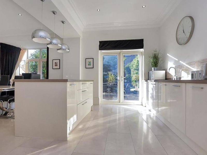 The bright and classy kitchen from another angle. The French doors lead the way into the garden.