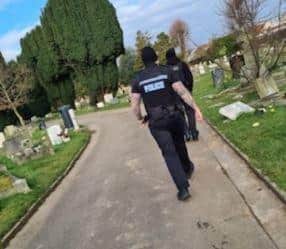 Police inspect the damage to graves at Ann's Hill Cemetery in Gosport.