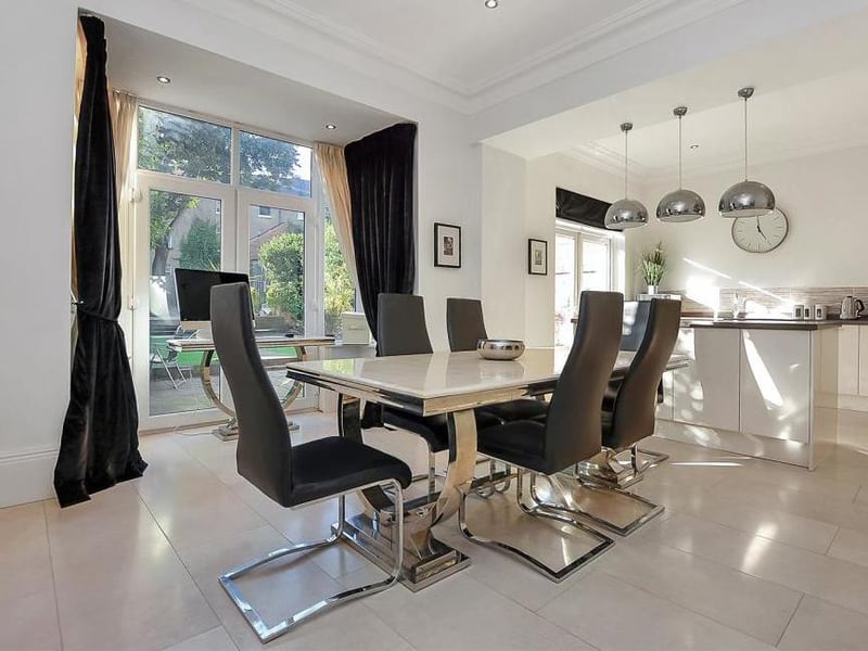 A dining table awaits your family in the superb, open-plan kitchen. Two sets of French doors lead out into the back garden.