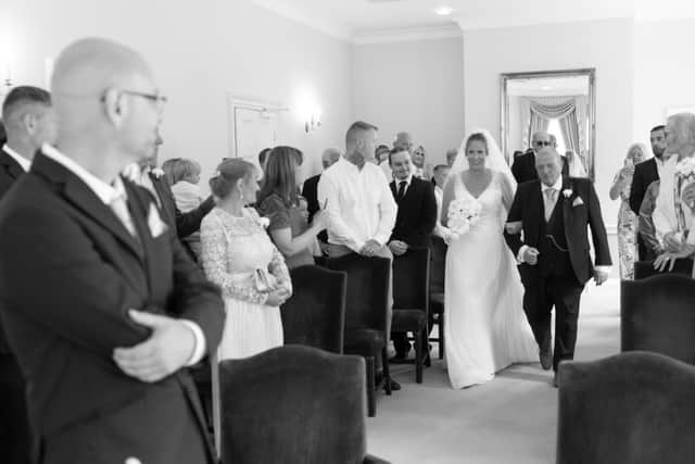 Natalie walking down the aisle. Credit: Weddings by Sophia B / www.besidetheseasidephotography.co.uk/