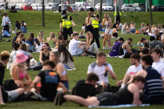 Police officers talk to groups of people enjoying the warm weather at the Forest Recreation Ground in Nottingham. Picture date: Wednesday March 31, 2021. PA Photo. The UK may be about to experience its hottest March on record with temperatures forecast to soar to around 25C (77F) Photo credit should read: Jacob King/PA Wire