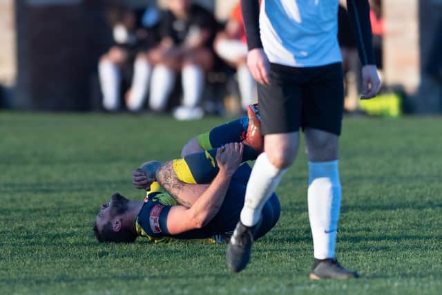 Steve Hutchings grimaces after being fouled against Stoneham.
Picture: Keith Woodland