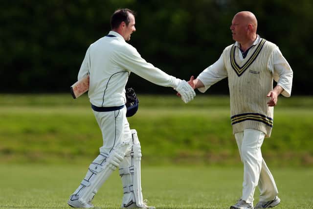 Portsmouth Community's David Going is congratulated by a Portsmouth 4ths player after his innings of 104.
Picture: Chris Moorhouse