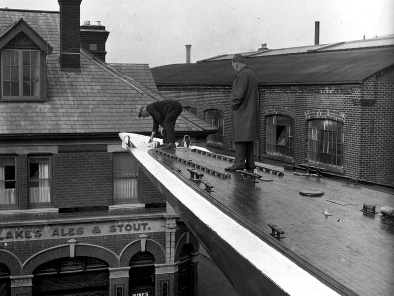 20th October 1937:  Mr T Sopwith's yacht, the 'Endeavour II', contender in the America's Cup Race spends the winter in the shipyard of Messrs Camper and Nicholson in Gosport, Hampshire. Raised up on stocks, its long bow protrudes over the wall.  (Photo by E. Dean/Topical Press Agency/Getty Images)