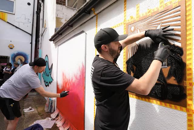 Korp, right, working on his Bring The Paint poster. Head jam at Head Hairdressing, Albert Rd, SouthseaPicture: Chris Moorhouse (jpns 120821-06)