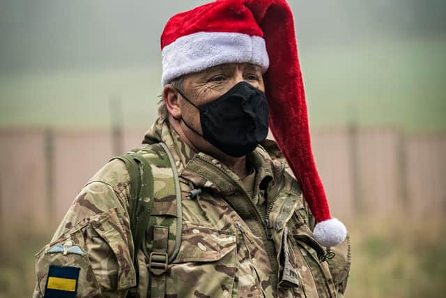 Reservists from 4 PWRR showed their Christmas spirit by slipping into Santa hats before receiving a festive meal in the field. Photo: Sgt Nick Johns RLC / MoD Crown
