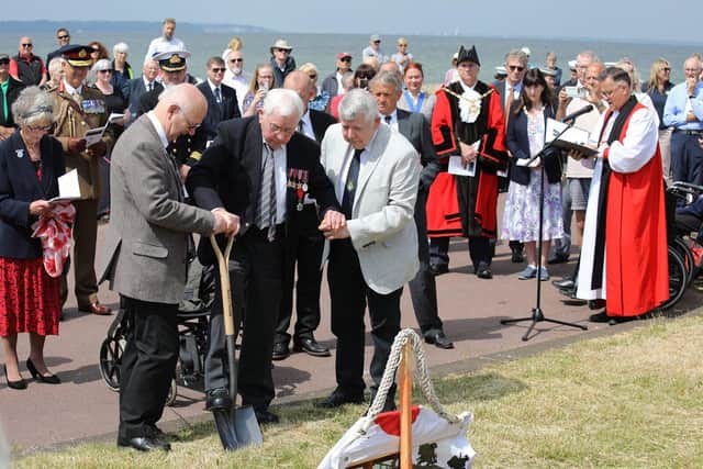 D-Day veteran George Carpenter digs the first sod for the D-Day Memorial planned for Stokes Bay