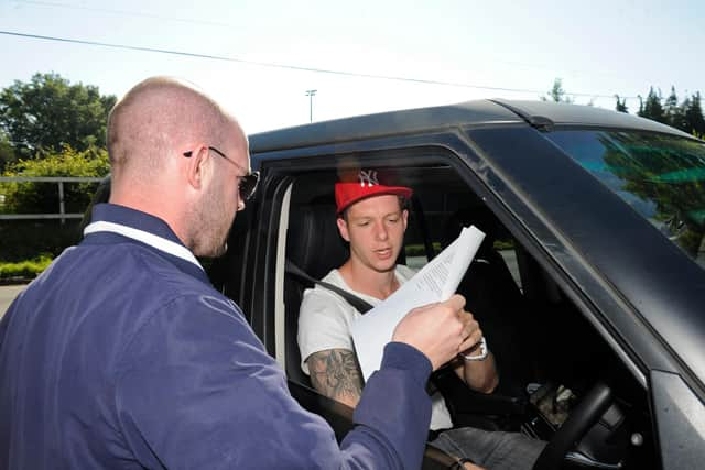 Carl Paddon, of SOS Pompey, hands over a letter to Greg  Halford at Pompey's training ground in Eastleigh. Halford agreed to leave the club to help it survive financially. Picture: Ian Hargreaves