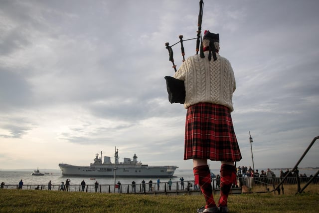 Piper Larry Cunningham plays his bagpipes as Britain's last serving aircraft carrier HMS Illustrious is towed from her home port at Portsmouth after being sold for scrap on December 7, 2016 in Portsmouth,. Photo by Matt Cardy/Getty Images