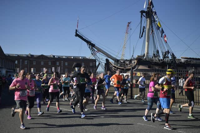 Participants in the Great South Run pass HMS Victory, in Portsmouth Historic Dockyard. Picture: Mary Turner