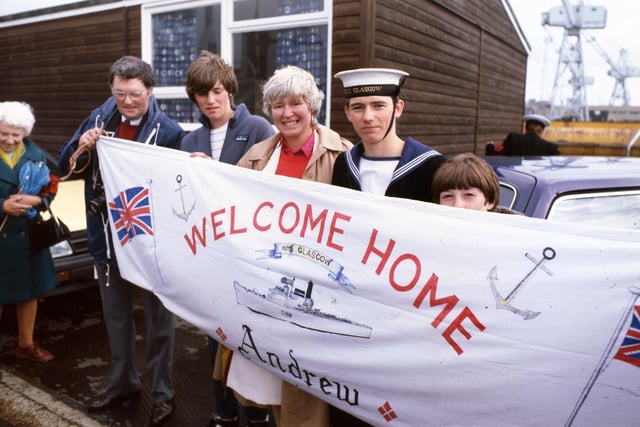 A sailor from HMS Glasgow with his friends and family on return