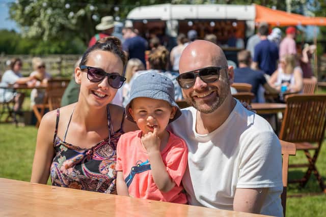 Rebecca Sheppard (34) with son Finley (3) and husband Ian Sheppard (38) enjoying a visit to Catherington Craft Fair. Picture: Mike Cooter (310521)