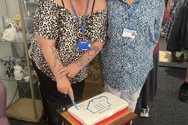 Sarah Knight with a volunteer inside the new shop.