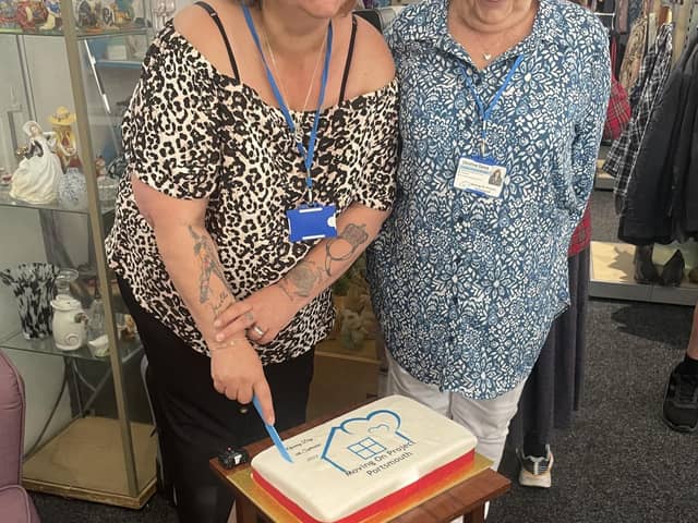 Sarah Knight with a volunteer inside the new shop.